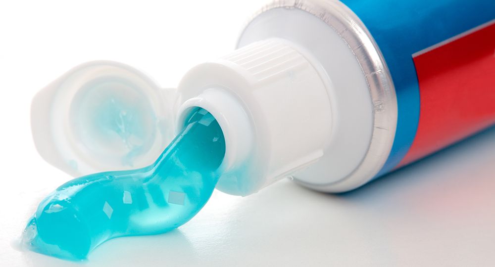 A,Tube,Of,Toothpaste,With,Breath,Strips.,White,Background.,Closeup.