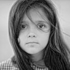 Black and white portrait of a child girl with sad expression. Hopeful concept