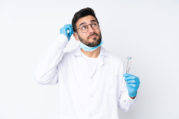 Dentist,Man,Holding,Tools,Isolated,On,White,Background,Having,Doubts